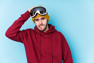 Young caucasian man wearing a ski clothes isolated being shocked, she has remembered important meeting.