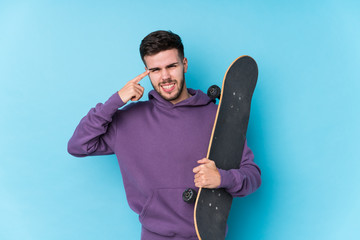 Young caucasian skater man isolated showing a disappointment gesture with forefinger.