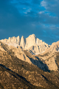 Mount Whitney is illuminated in beautiful light at sunrise as seen from the Alabama Hills near Lone Pine, California.