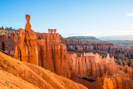 A beautiful sunrise illuminates Thor's Hammer in Bryce Canyon National Park as seen from Sunset Point on the Navajo Trail, Utah.