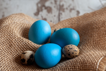 Blue Easter eggs on burlap background