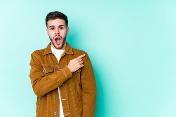 Young handsome man pointing to the side