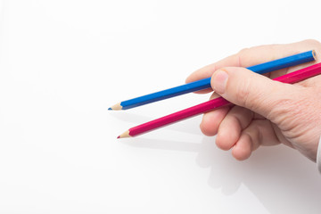 Colored pencil in the hand of an adult person