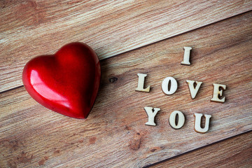 Red heart and text I Love You on wooden background. Valentine's day, mother's day, birthday, celebration concept