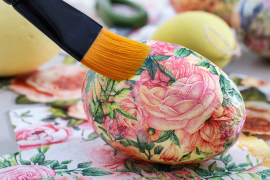 Decorating Easter eggs with decoupage technique.