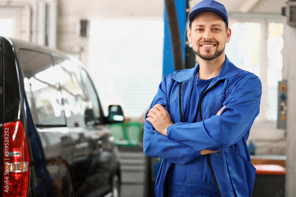 Wall mural Male mechanic in car service center