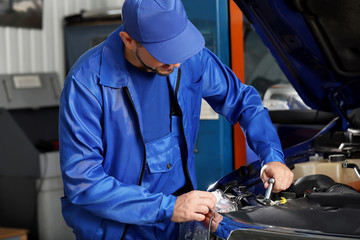 Male mechanic working in car service center