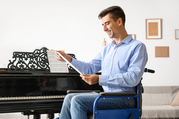 Young man in wheelchair at grand piano