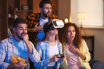 Friends playing video game at home