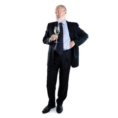 Senior man standing on white background and holding glass of white wine