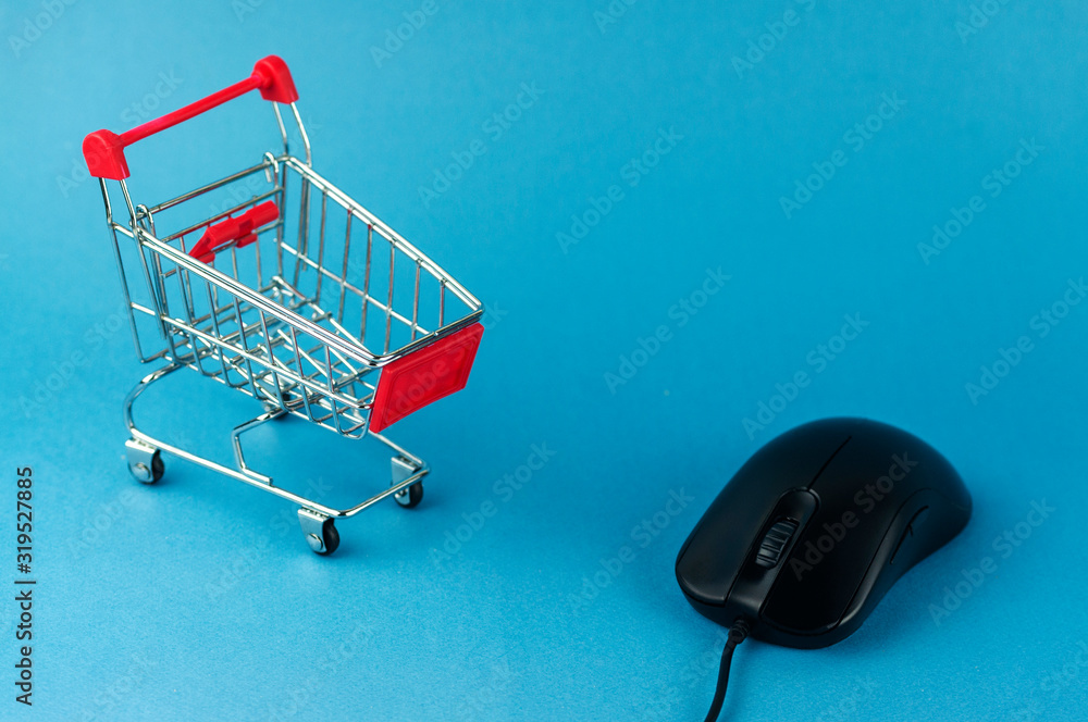 Wall mural shopping cart and computer mouse, online shopping concept