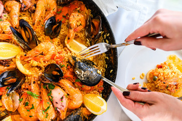 Spanish paella with seafood served in a pan. Fresh Shrimp, Scampi, mussels, squid, octopus and...