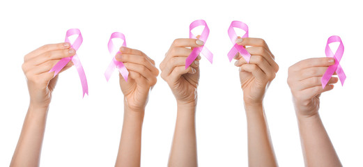 Female hands with pink ribbons on white background. Cancer awareness concept