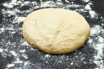 Raw dough on a black background.