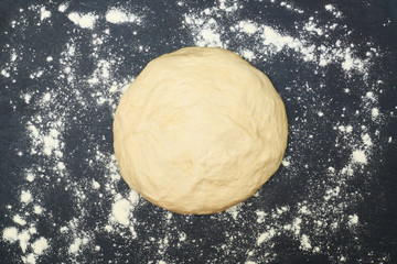 Raw dough on a black background.