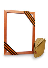 Wooden portrait frame with St. George ribbon and cap. Isolated on a white background.