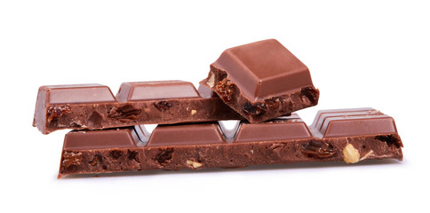 Milk chocolate. Chunks of chocolate with hazelnuts and raisins isolated on white background with clipping path. 