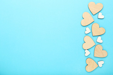 Brown and white wooden hearts on blue background