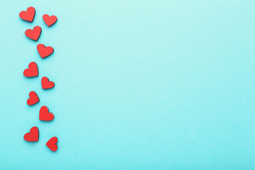 Red wooden hearts on blue background