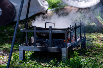 Kitchen of a rural camp, with pot on top of a bonfire