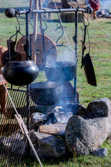Kitchen of a rural camp, with pot on top of a bonfire