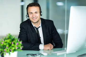 Businessman talking on the pc with headset in the office