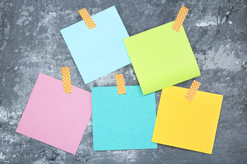 Paper sticky notes on grey background