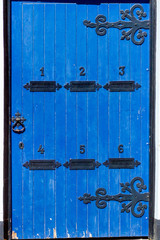Lovely historic blue wooden door with six letterboxes in Ware, UK