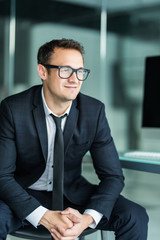 Obraz premium Portrait of young businessman in modern office. looking camera