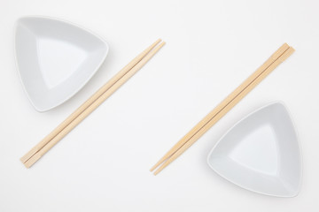 Top View Of White Empty Sushi Plates With Bamboo Chopsticks.