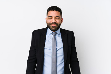 Young latin business woman against a white background isolated laughs and closes eyes, feels relaxed and happy.