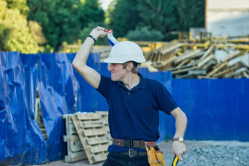 Young workman with helmet enjoy dancing while listening to music