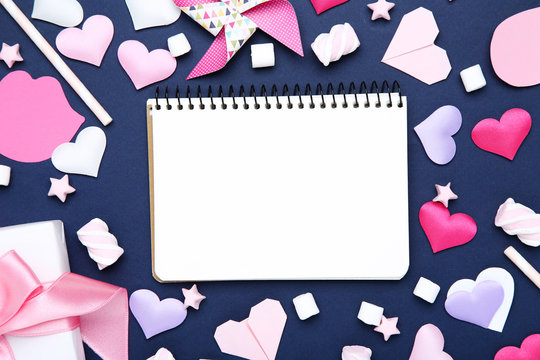 Valentine hearts with blank notepad, marshmallows and gift box on blue background - Powered by Adobe