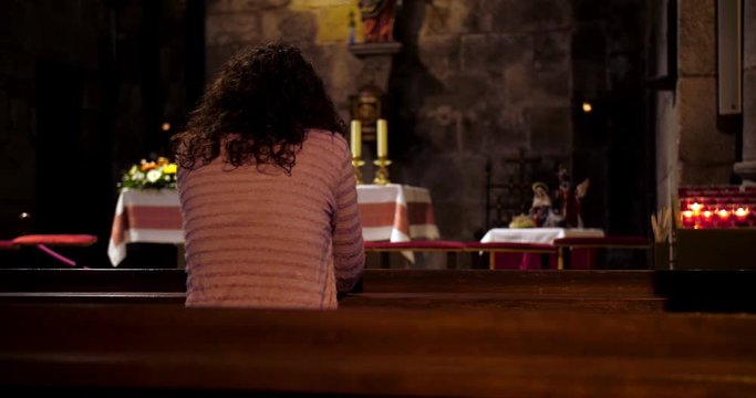 Young woman praying at church