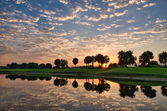 sunrise water reflection at a golf course