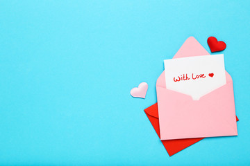 Paper envelopes with hearts and text With Love on blue background