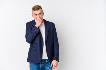 Young business caucasian man thoughtful looking to a copy space covering mouth with hand.