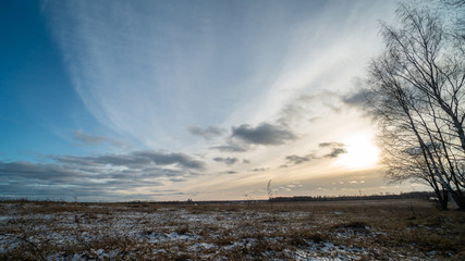 Beautiful setting sun over frozen field