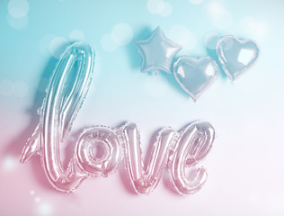 LOVE word and heart balloons on color background. Valentine's day