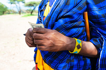 African man counting money, counting dollars.