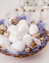 big basket with quail and chicken eggs ready for coloring