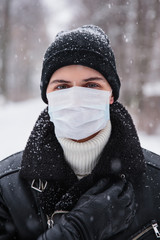 Fototapeta na wymiar Alarmed female traveler wears medical mask to protect against coronavirus, afraid of infection. Deadly coronavirus in China 2019 2020 2019-nCoV
