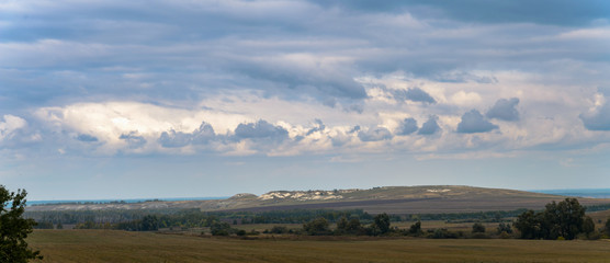 Photo of a summer landscape with fields and chalk hills