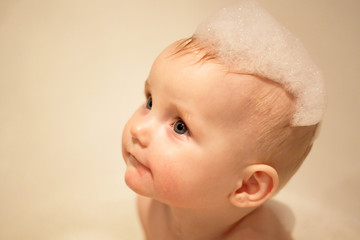 little girl bathes in a bath