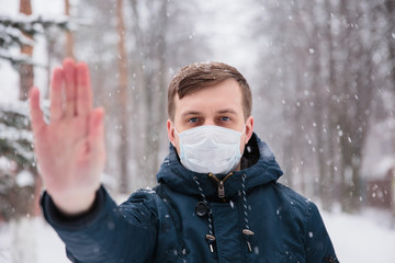 Alarmed male appearance wears medical mask protect against coronavirus afraid infection. Deadly coronavirus China 2019 2020 2019-nCoV. Sign protest, outstretched hand forward