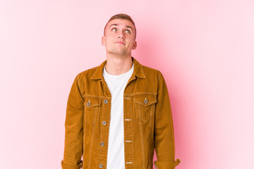 Young caucasian man isolated dreaming of achieving goals and purposes