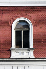 Wooden window, brick facade