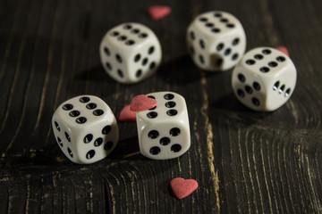 on the old wooden table are dice with hearts