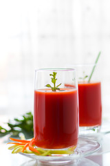 Fresh tomato juice with carrots and celery, vertical orientation