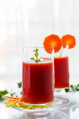 Fresh tomato juice with carrots and celery, vertical orientation